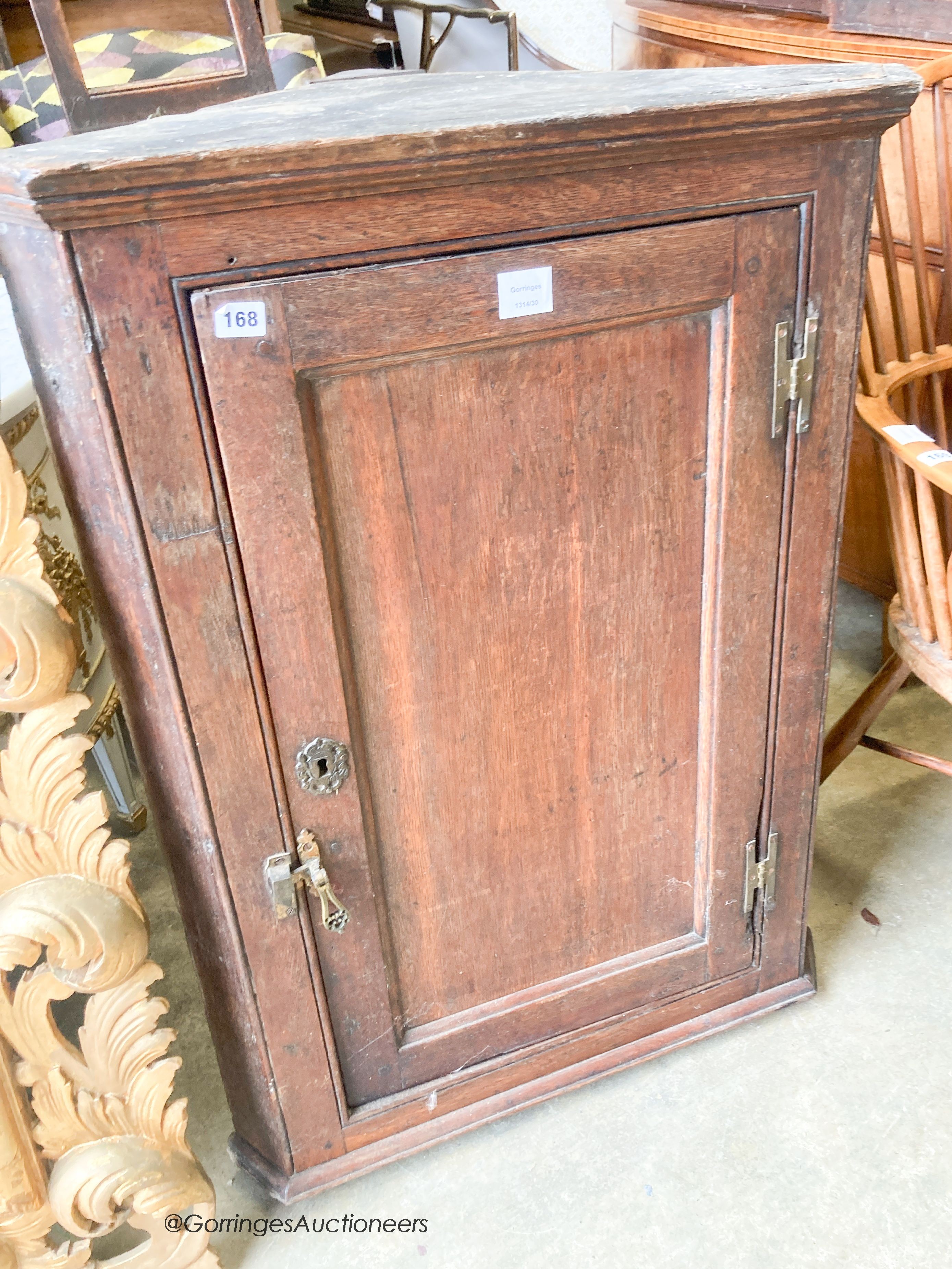 An 18th century oak hanging corner cupboard, width 70cm, depth 41cm, height 99cm